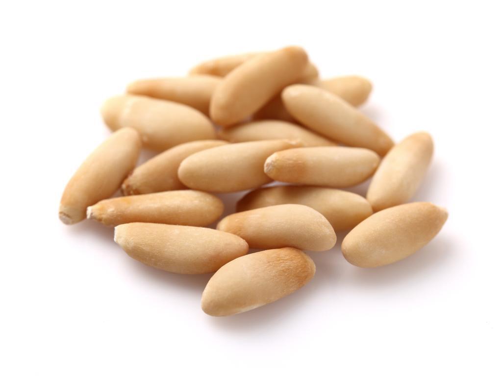 Close up of pine nuts without the shells on.