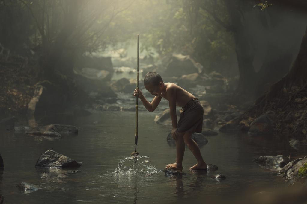 Photo of a boy spear fishing with one of the best hunting survival spears.