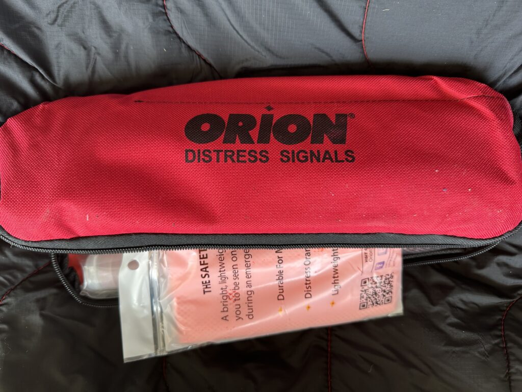 Image of a bag of distress signal (road flares) in the back of a vehicle.