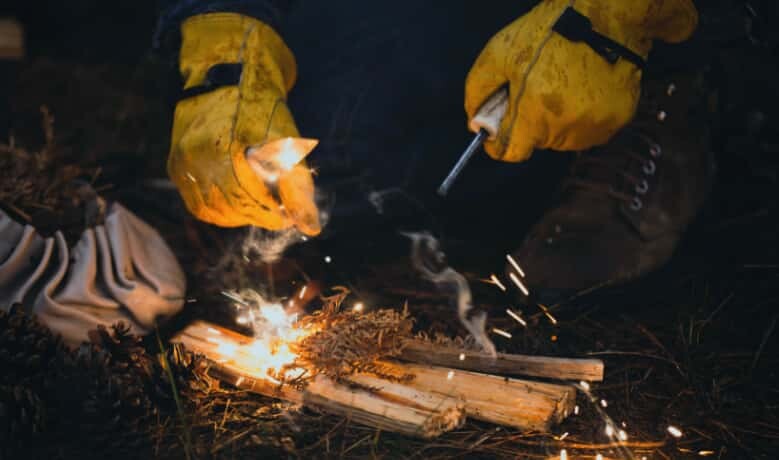 Photo of a person starting a fire.
