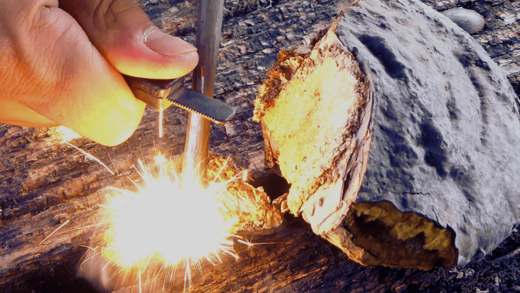 Photo of a person using a bushcraft fire starting tool.