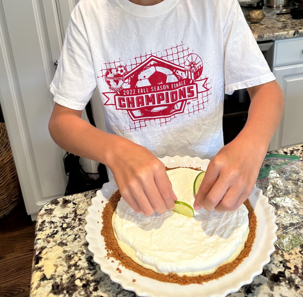 Photo of my son topping a pie he made for my husband's birthday.