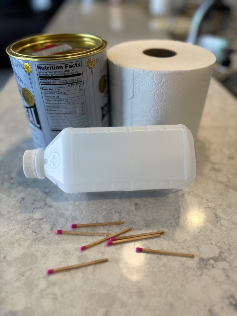 Photo of matches, toilet paper roll, metal can and isopropyl alcohol. An example of emergency heaters you can make at home.
