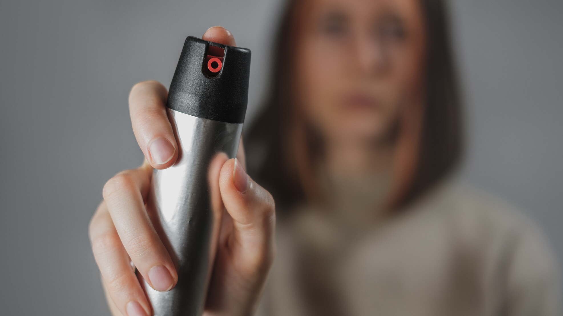 Woman prepared to use a can of bear spray.