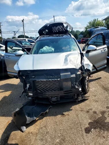 Photo of the front of a car that has been wrecked.