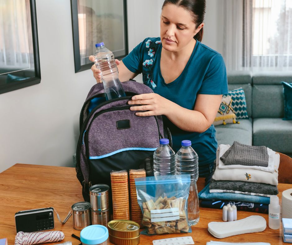 Photo of a woman packing a bug out bag.